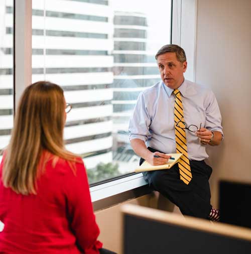 Attorney Mark Dix speaking with client in office